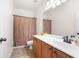 Bathroom features a vanity with wood cabinets, white countertop, and neutral-colored shower curtain at 1945 Bay Beauty Ln # 10, Austell, GA 30106