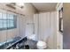 This bathroom features a window that allows for ample natural lighting and a tub with a shower curtain at 2284 Emerald Springs Dr, Decatur, GA 30035