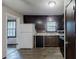 Functional kitchen featuring dark cabinetry, laminate countertops, and standard appliances at 2284 Emerald Springs Dr, Decatur, GA 30035