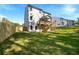 Exterior view of backyard featuring a spacious lawn, and a newly-built deck and stairwell at 2460 Hidden Creek Rd, Kennesaw, GA 30152