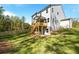 Exterior view of the backyard and back of the house with a deck and stairs to the lawn at 2460 Hidden Creek Rd, Kennesaw, GA 30152