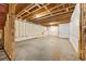 Unfinished basement with exposed ceiling and concrete floor, framed walls and insulation at 2460 Hidden Creek Rd, Kennesaw, GA 30152