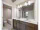 Bright bathroom featuring double vanity with white countertops and a large mirror at 2460 Hidden Creek Rd, Kennesaw, GA 30152