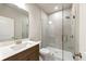 Modern bathroom with glass-enclosed shower, a dual sink vanity, and stylish fixtures at 2460 Hidden Creek Rd, Kennesaw, GA 30152