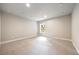 Bright bedroom with neutral walls, carpet, and a window bringing in natural light at 2460 Hidden Creek Rd, Kennesaw, GA 30152