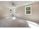 Spacious carpeted bedroom bathed in natural light from three large windows at 2460 Hidden Creek Rd, Kennesaw, GA 30152