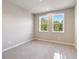 Neutral bedroom featuring plush carpet, bright windows, and a calming color scheme at 2460 Hidden Creek Rd, Kennesaw, GA 30152