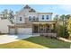 Charming two-story home featuring gray siding, brick accents, a welcoming front porch, and a lush green lawn at 2460 Hidden Creek Rd, Kennesaw, GA 30152