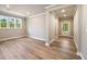 Spacious living area featuring wood floors, neutral walls, and natural light from several windows at 2460 Hidden Creek Rd, Kennesaw, GA 30152