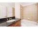 This bathroom features a marble vanity, tile surround, and a bathtub with shower at 2661 Rivers Edge Ne Dr, Atlanta, GA 30324