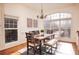 Bright dining room featuring hardwood floors, wainscoting, modern chandelier, and large window at 2661 Rivers Edge Ne Dr, Atlanta, GA 30324