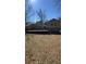 View of the house's backyard featuring a wooden deck and lush green trees at 3924 Veracruz Dr, Decatur, GA 30034