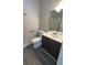 Compact bathroom with sleek vanity, modern fixtures, toilet, and shower with white tile at 3924 Veracruz Dr, Decatur, GA 30034