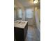 Functional bathroom with a white vanity, tiled floors, shower and toilet at 3924 Veracruz Dr, Decatur, GA 30034