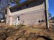 Exterior view of home with brick, white trim and a small wooden deck on the side of the house at 3924 Veracruz Dr, Decatur, GA 30034