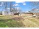 Full view of the property's spacious backyard, deck, shed, and covered parking at 765 Shellnut Dr, Forest Park, GA 30297