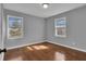 Bedroom with hardwood floors, two windows and neutral gray paint at 765 Shellnut Dr, Forest Park, GA 30297