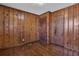 Bedroom featuring wood floors, wood paneling, and two doors at 765 Shellnut Dr, Forest Park, GA 30297