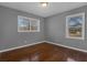 Bedroom featuring wood floors, fresh paint, and two windows that bring in natural light at 765 Shellnut Dr, Forest Park, GA 30297