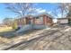 Charming brick home featuring a covered carport, well-maintained landscaping, and a welcoming blue front door at 765 Shellnut Dr, Forest Park, GA 30297