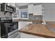 Kitchen featuring wood countertops and stainless steel oven and microwave at 765 Shellnut Dr, Forest Park, GA 30297