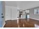 Inviting living space with hardwood floors adjacent to the modern kitchen with white cabinets and blue accents at 765 Shellnut Dr, Forest Park, GA 30297