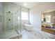 Open bathroom boasts a glass enclosed shower and freestanding bathtub at 1826 Terry Mill Se Rd, Atlanta, GA 30316