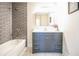 Bathroom featuring a tub with grey subway tile and a modern vanity with a white countertop at 1826 Terry Mill Se Rd, Atlanta, GA 30316