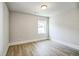 A bright bedroom with light wood floors, white trim, and a large window with a view at 1826 Terry Mill Se Rd, Atlanta, GA 30316