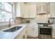 Modern kitchen featuring white countertops, stainless steel appliances, ample cabinet space, and stylish faucet at 1826 Terry Mill Se Rd, Atlanta, GA 30316