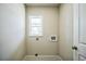 A well-lit laundry room with a window and hookups for a washer and dryer at 1826 Terry Mill Se Rd, Atlanta, GA 30316