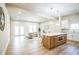 Spacious open-concept living area with hardwood floors, modern kitchen island, and sliding glass doors at 1826 Terry Mill Se Rd, Atlanta, GA 30316