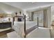 Serene main bedroom showcasing a decorative headboard, soft lighting, and calming neutral tones at 3112 Neal Ct, Cumming, GA 30041