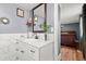 Bathroom vanity boasts marble countertops and modern fixtures, adjacent to a view of the bedroom at 1474 Harbins Rd, Norcross, GA 30093