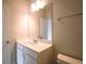 Clean bathroom with white vanity, ample lighting, and a large mirror, designed for comfort and functionality at 1480 Baygreen Rd, Suwanee, GA 30024
