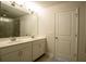 Bathroom featuring double sinks, a large mirror, and a separate shower area at 1480 Baygreen Rd, Suwanee, GA 30024