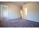 Carpeted bedroom with neutral walls, multiple doors, and a view of other rooms at 1480 Baygreen Rd, Suwanee, GA 30024