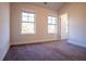 A bright, carpeted bedroom with two windows and neutral paint at 1480 Baygreen Rd, Suwanee, GA 30024