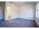 A bright and spacious carpeted bedroom with a view of the ensuite bathroom at 1480 Baygreen Rd, Suwanee, GA 30024