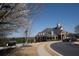 Attractive clubhouse with manicured landscaping, trees, and a road with parked cars at 1480 Baygreen Rd, Suwanee, GA 30024