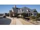 Image displays the clubhouse exterior featuring traditional architecture, manicured landscaping and sidewalk at 1480 Baygreen Rd, Suwanee, GA 30024