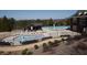 An aerial view of a community pool and clubhouse featuring patio furniture at 1480 Baygreen Rd, Suwanee, GA 30024