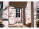Inviting front door with sidelights set in white brick, creating a warm and welcoming entrance at 1480 Baygreen Rd, Suwanee, GA 30024
