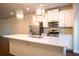 Well-equipped kitchen with stainless steel appliances, white cabinetry, and an island with a sink at 1480 Baygreen Rd, Suwanee, GA 30024