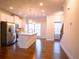Bright kitchen with white cabinets, stainless steel appliances, hardwood floors, and a large center island at 1480 Baygreen Rd, Suwanee, GA 30024
