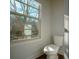 Bright powder room featuring a window view, a toilet, and a convenient location at 1480 Baygreen Rd, Suwanee, GA 30024