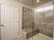 Modern shower with glass enclosure, seating, and tiled walls, offering a luxurious experience at 1480 Baygreen Rd, Suwanee, GA 30024