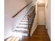 Elegant staircase with hardwood treads, iron railing, and natural light, adding a touch of sophistication to the home at 1480 Baygreen Rd, Suwanee, GA 30024