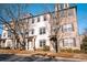 Elegant townhouse with mixed brick and stucco facade, featuring well-maintained landscaping and classic architectural details at 1480 Baygreen Rd, Suwanee, GA 30024