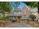 Charming home with brick and gray siding, complemented by lush landscaping and a well-maintained front yard at 146 River Ridge Ln, Roswell, GA 30075